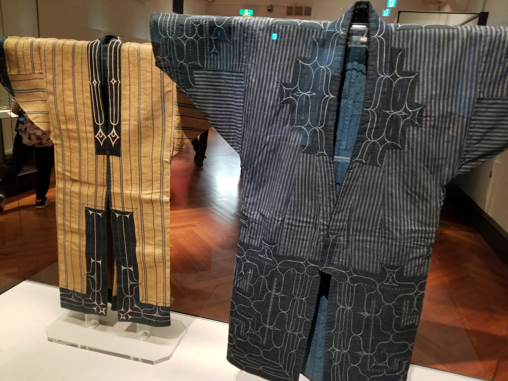 Two traditional Ainu robes on display.